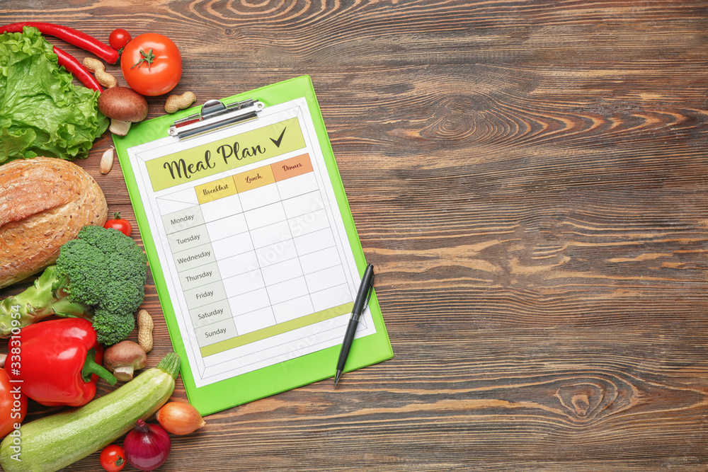 Healthy products and meal plan on wooden background