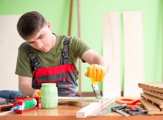 Wall Mural - Young man carpenter working in workshop