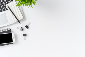 Wall Mural - Overhead shot of modern workplace with laptop and accessories on white table with copyspace. Office desktop. Flat lay