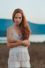 Wall Mural - Incredible young woman with long curly hair and freckles face.