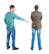 © ghoststone - Back view of two man in sweater pointing.
