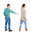© ghoststone - Back view of two man in sweater pointing.