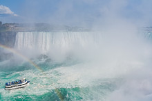 Panorama Of The Canadian Side Of The Falls, With A Tourist Boa Tand Rainbow. Concept Of Travel And Tourism. Niagara Falls, Canada. United States Of America