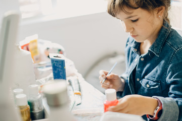 Wall Mural - portrait of young child girl crafting at home