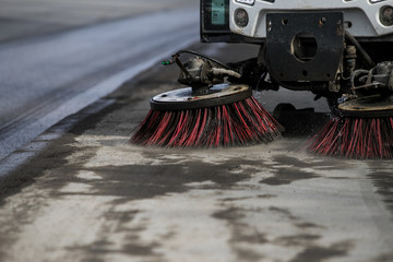 Wall Mural - Street cleaner vehicle on the road collecting garbage and junk with brush rotation and vacuum hoover