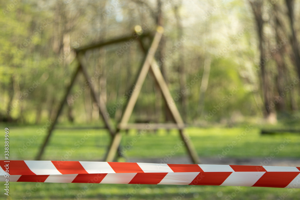 cordoned off playground with children's swing, surroundet by trees, forcus on barrier tape Stock ...