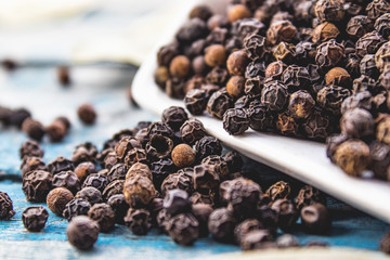 Wall Mural - The black pepper is scattered on blue boards.