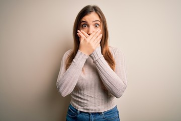 Sticker - Beautiful young woman standing casual over isolated background shocked covering mouth with hands for mistake. Secret concept.