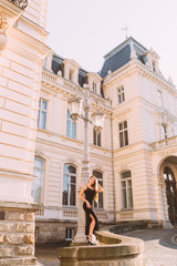 Wall Mural - building with beautiful architecture and girl in black dress nea