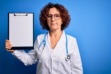 Poster - Middle age curly hair doctor woman wearing coat and stethoscope holding clipboard with a confident expression on smart face thinking serious