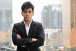 © Ranta Images - Portrait of young handsome Asian businessman with arms crossed in the city
