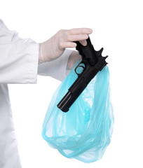 Man in gloves putting gun into package