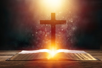 Wall Mural - open book on old wooden table with cross