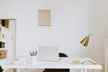 Wall Mural - Modern minimal interior design concept. Bright Scandinavian home office desk table workspace with laptop, lamp, books. Business study cabinet. Girl boss studio concept.