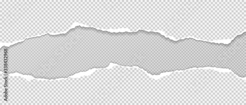 Fotografía Pieces of torn white paper with soft shadow stuck on grey squared background