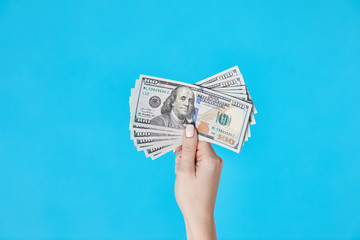 Close up of Hand with Money. American dollars banknotes in hand, business concept.