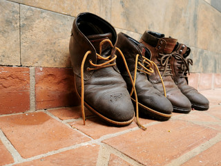 boots drying on the ground bricks