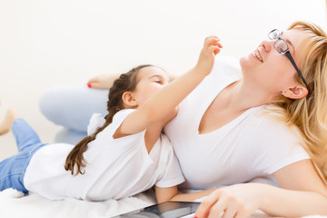 Canvas Print - Mom and daughter using tablet