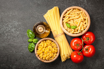 Wall Mural - Pasta, tomatoes and olive oil on black