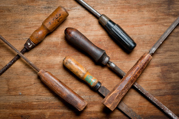 Old vintage screwdrivers and files of the last century extracted from the chest in the workshop of grandfather. Background for craftsmanship and manual labor.