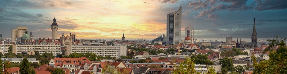 Panorama of the city of Leipzig, Saxony, with tall buildings, town hall and churches with an interesting colored sky - obrazy, fototapety, plakaty 