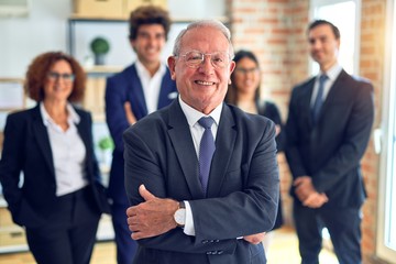 Group of business workers smiling happy and confident in a meeting. Standing with smile on face looking at camera at the office.