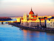 View of the Hungarian Parliament Building and the Danube river at sunset in Budapest, Hungary.
