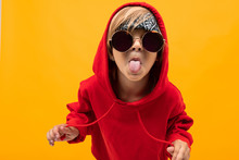 Cool Young Boy In Red Hoody And White T-shirt, Picture Isolated On Orange Background