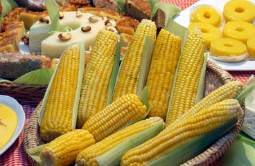 Typical food from the June festivities in northeastern Brazil at table. Cakes, rennet cheese, corn, mush, hominy, tapioca and coffee