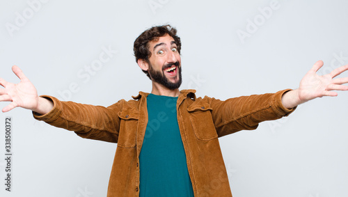 Cuadros en Lienzo young handsome man smiling cheerfully giving a warm, friendly, loving welcome hu