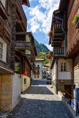 Wall Mural - Street and typical wooden chalets in Zermatt village by day, Switzerland