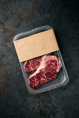 Raw beef Striploin steak in vacuum packaging, mockup for the logo design idea