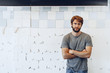 © fotofabrika - Close up Portrait of a young bearded man standing against grunge weathered wall