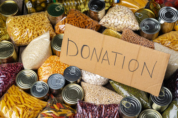 Poster - Food donations on the table. Text Donation. Close up.