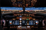 Fototapeta  - Dramatic Full view of cockpit modern Boeing aircraft before take-off. Airplane is ready to fly. Night shot in cabin. Safety flight