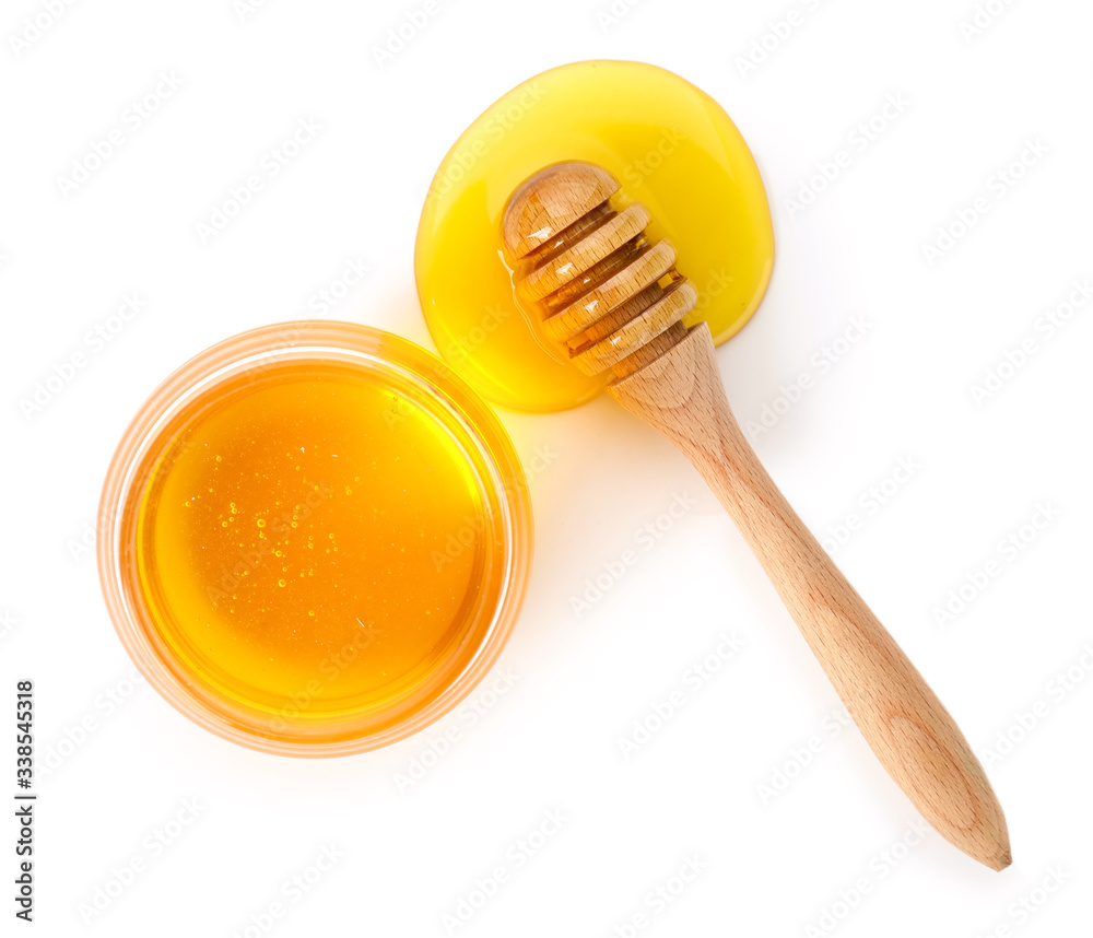 Jar of sweet honey and dipper on white background