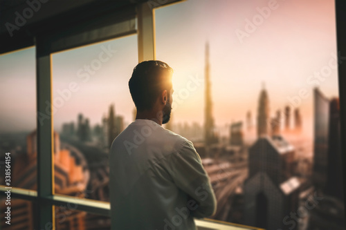 Cuadros en Lienzo Arabic business man looking out through the office balcony seen through glass window
