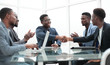 © ASDF - happy business partners shaking hands at meeting in the office.