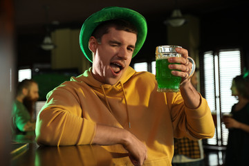 Sticker - Man with glass of green beer in pub. St. Patrick's Day celebration