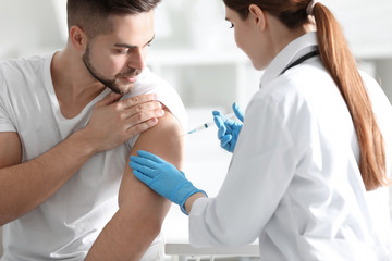 Poster - Doctor giving injection to patient in hospital. Vaccination concept