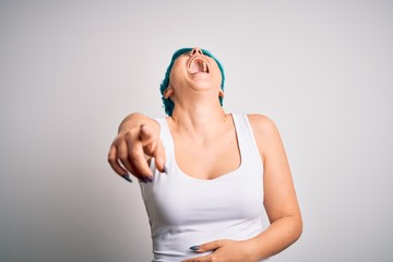 Sticker - Young beautiful woman with blue fashion hair wearing casual t-shirt over white background laughing at you, pointing finger to the camera with hand over body, shame expression