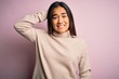 © Krakenimages.com - Young beautiful asian woman wearing casual turtleneck sweater over pink background confuse and wonder about question. Uncertain with doubt, thinking with hand on head. Pensive concept.