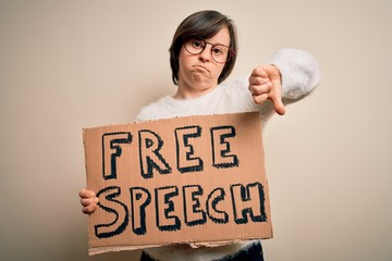 Sticker - Young down syndrome woman holding protest banner of free speech for communication rights with angry face, negative sign showing dislike with thumbs down, rejection concept