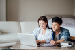 © JodieWang - Young Asian couple at home using computer