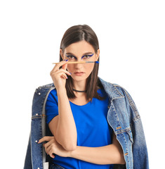 Wall Mural - Portrait of fashionable young woman with paint brush on white background