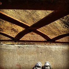 High Angle View Of Shoes In Front Of Railings
