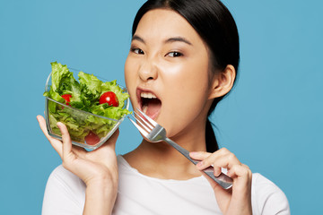 young woman eating salad