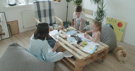 Wall Mural - Happy mom and cute kids using laptop at home