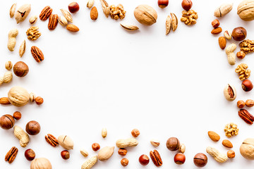 Wall Mural - Nuts background - with almond, macadamia, walnut - on white table top-down frame copy space