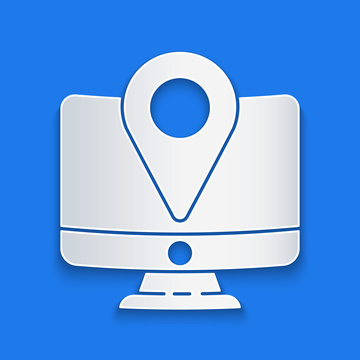 Paper cut Computer monitor and folded map with location marker icon isolated on blue background. Paper art style. Vector Illustration